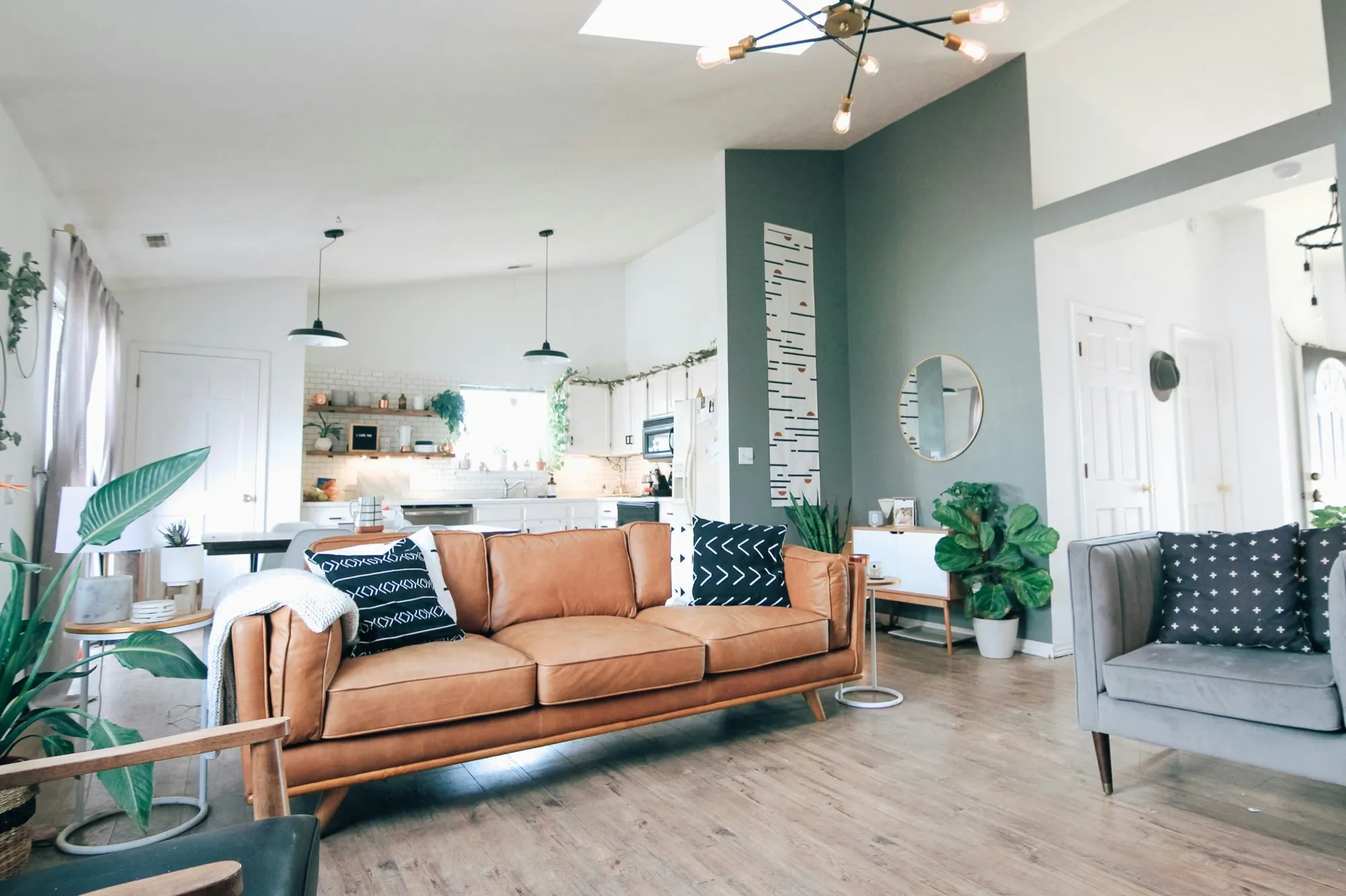 A bright, welcoming living room with a sofa and plants